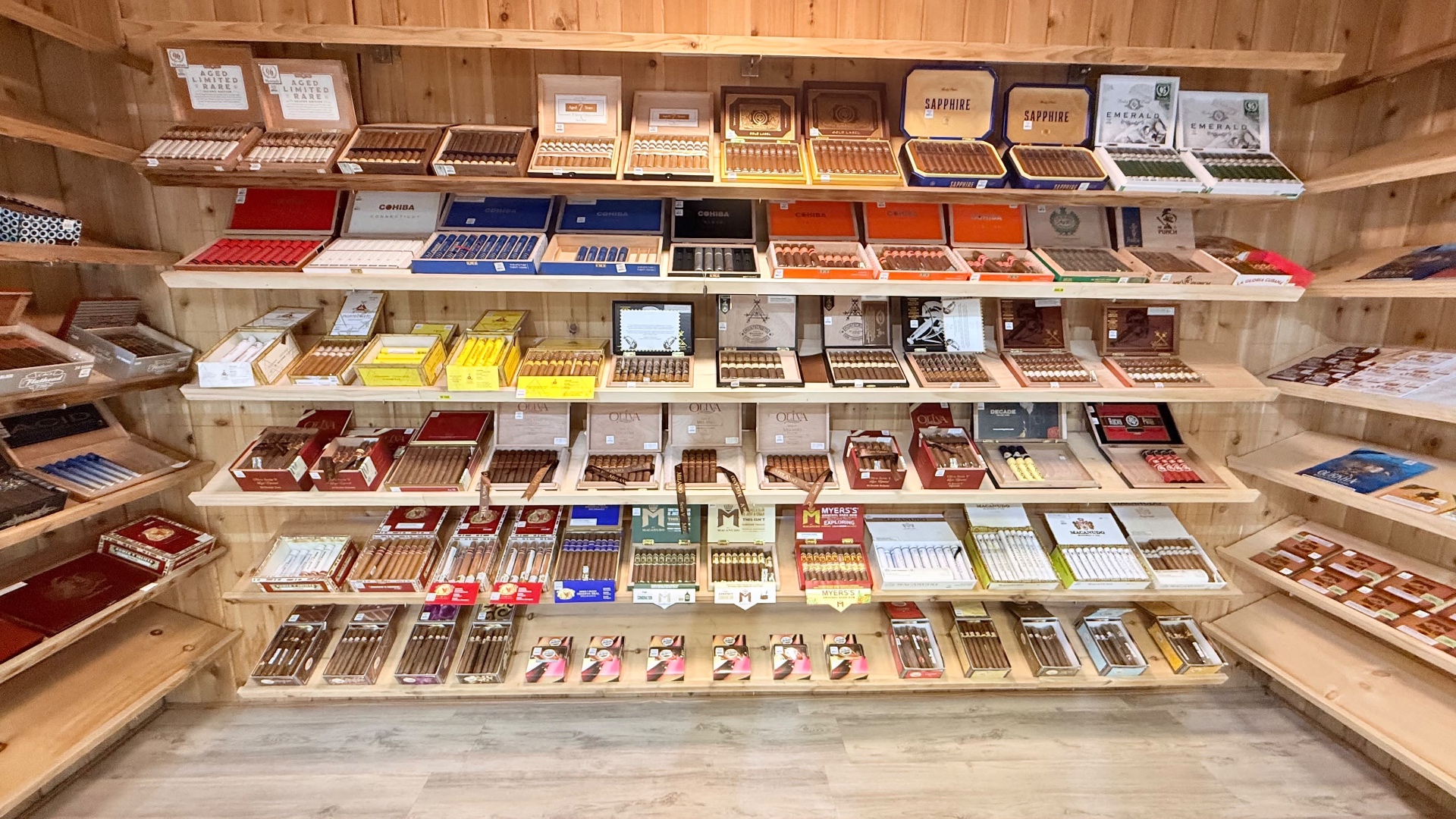 The walk-in cigar humidor at Green House Smoke Shop on Vineland Rd in Kissimmee, Florida, with cedar shelves of Cohiba, Montecristo, Oliva, Macanudo and Rocky Patel boxes